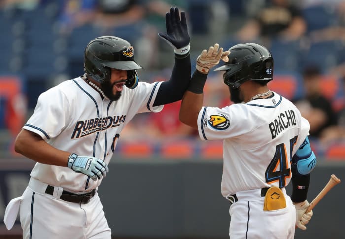 Akron RubberDucks left fielder Jonathan Rodriguez, left, high fives teammate Aaron Bracho after hitting a two-run homer against the Richmond Flying Squirrels during the first inning of a Minor League Baseball game at Canal Park, Thursday, July 20, 2023, in Akron, Ohio.